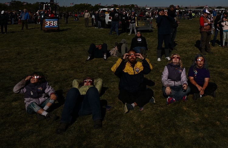 در اینجا پاتریک فالون عکاس AFP، جمعیتی از تماشاگران را با عینک مخصوص خورشید گرفتگی در حالی که در حال تماشای این کسوف هستند، به تصویر می‌کشد.
